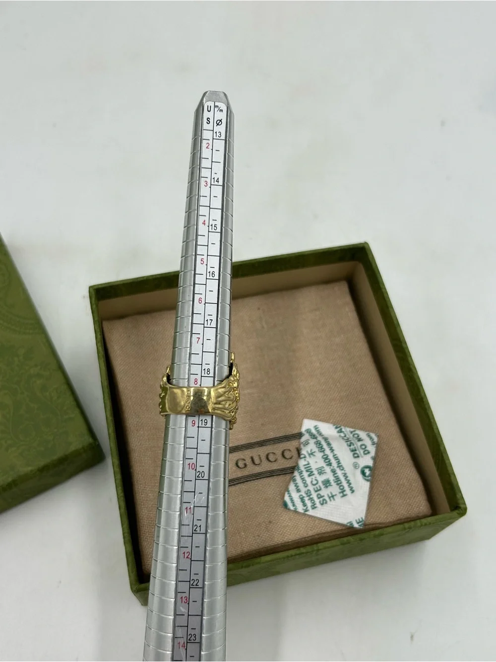Unisex Gucci, Lionhead motif  gold tone with red crystal size 8.5 made in Italy
